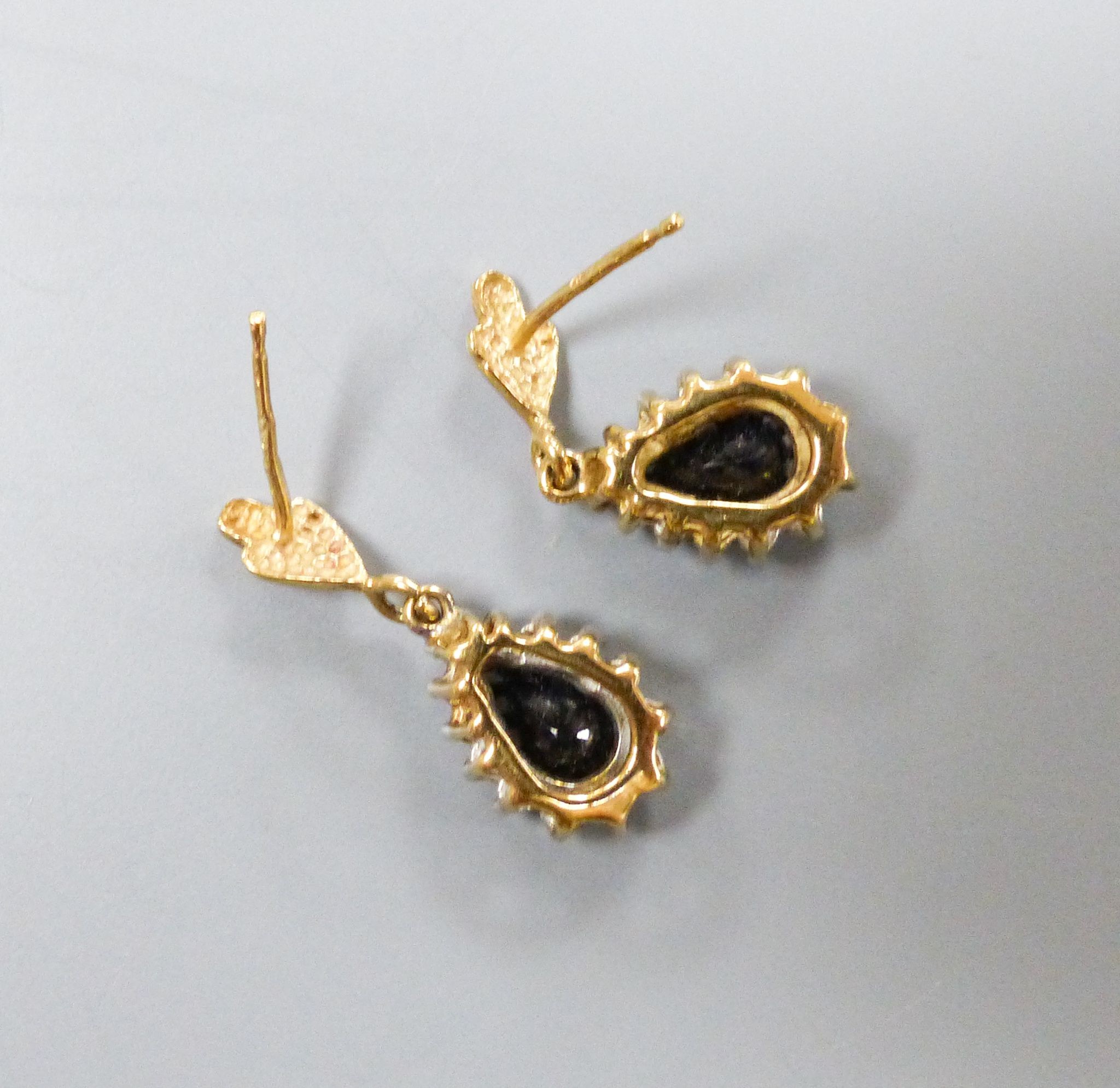 A pair of sapphire and diamond pear shaped stud earrings, 9ct gold setting, no butterflies, 11mm, gross weight 1.8 grams.